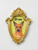Hand-painted pet portrait in a shield-shaped vintage-style gold magnet frame.