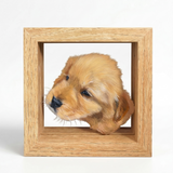 Hand-painted puppy portrait extending beyond a layered light wood frame.