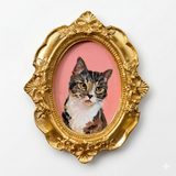 Hand-painted cat portrait in an oval vintage-style gold magnet frame with a pink background.