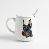 White lidded ceramic mug with a hand-painted Doberman portrait.
