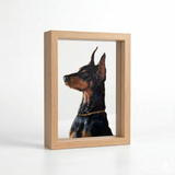 Hand-painted Doberman portrait displayed in a layered light wood frame with depth.