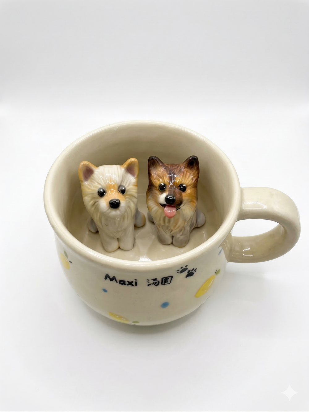 Ceramic mug with two miniature dog figurines inside the cup.